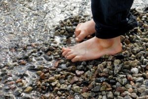 8305324-two-small-feet-on-pebbles-on-the-beach